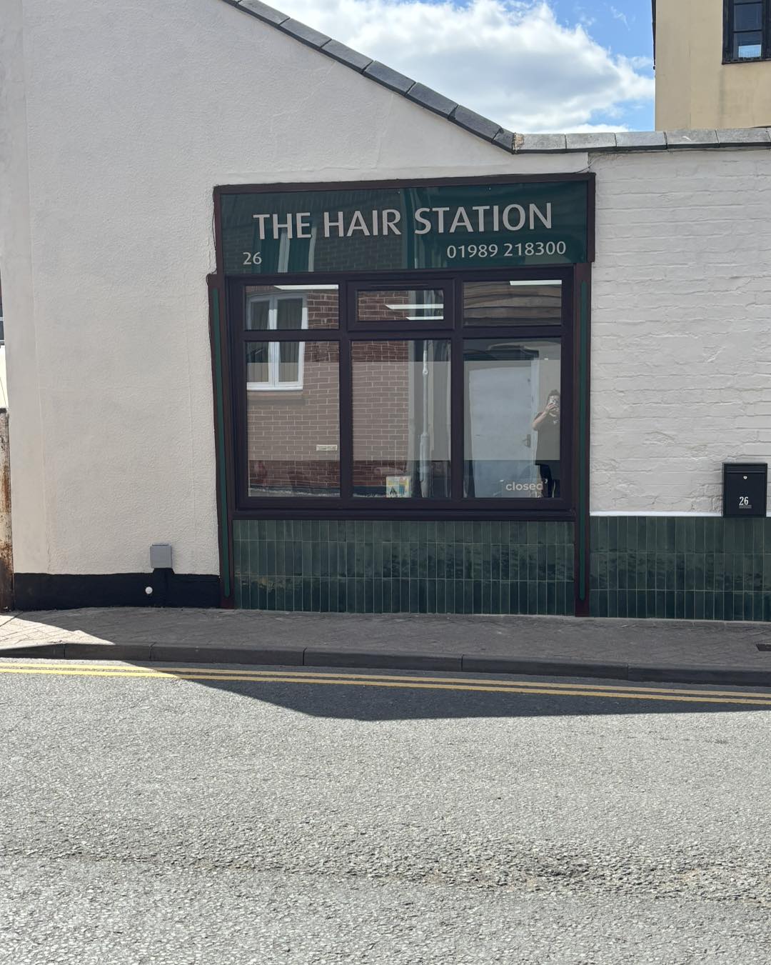 The Hair Station shopfront on Station Street, with its dark green sign and window